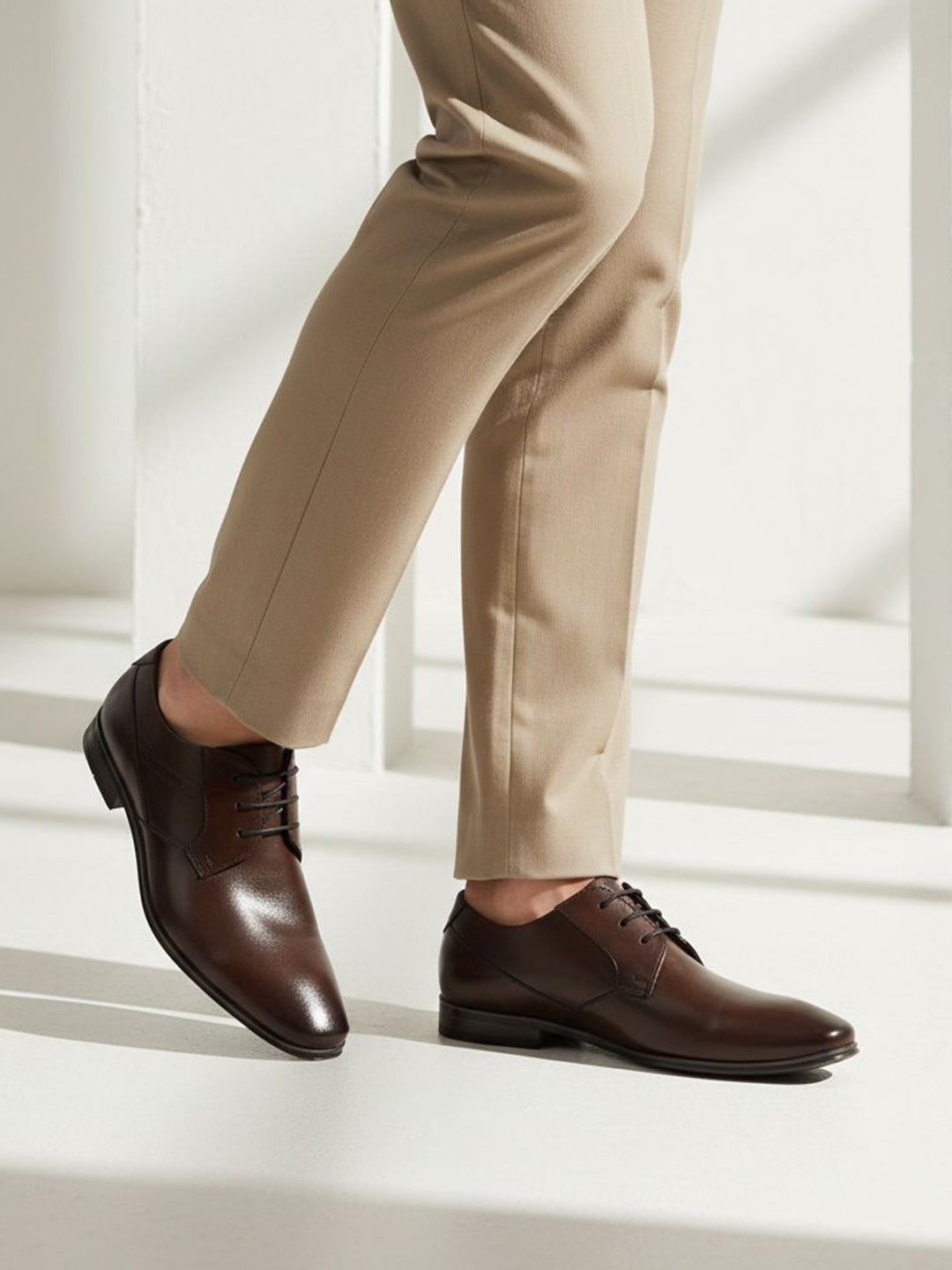 bugatti Morino I dark brown premium leather derby formal shoes, styled with tan trousers.
