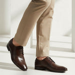 bugatti Morino I dark brown premium leather derby formal shoes, styled with tan trousers.
