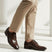 bugatti Morino I dark brown premium leather derby formal shoes, styled with tan trousers.
