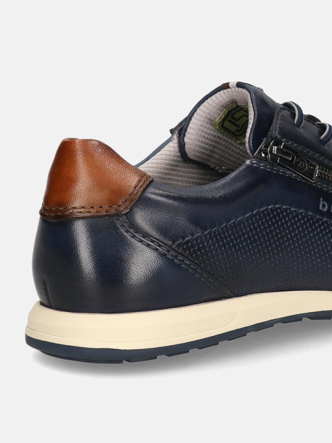 Cropped view of a bugatti Thorello sneaker in dark blue premium leather with a brown heel cap and side zipper.