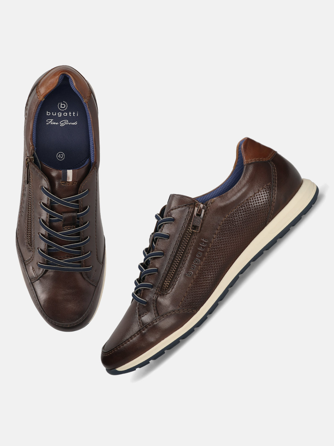 Brown leather sneakers by bugatti, featuring navy laces and side zipper detail, on a plain background.