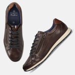 Brown leather sneakers by bugatti, featuring navy laces and side zipper detail, on a plain background.
