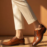 bugatti Menello cognac leather derby shoes with black laces, paired with beige pants.