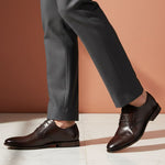 bugatti Gapo dark brown premium leather derby shoes with laces, paired with gray dress pants.
