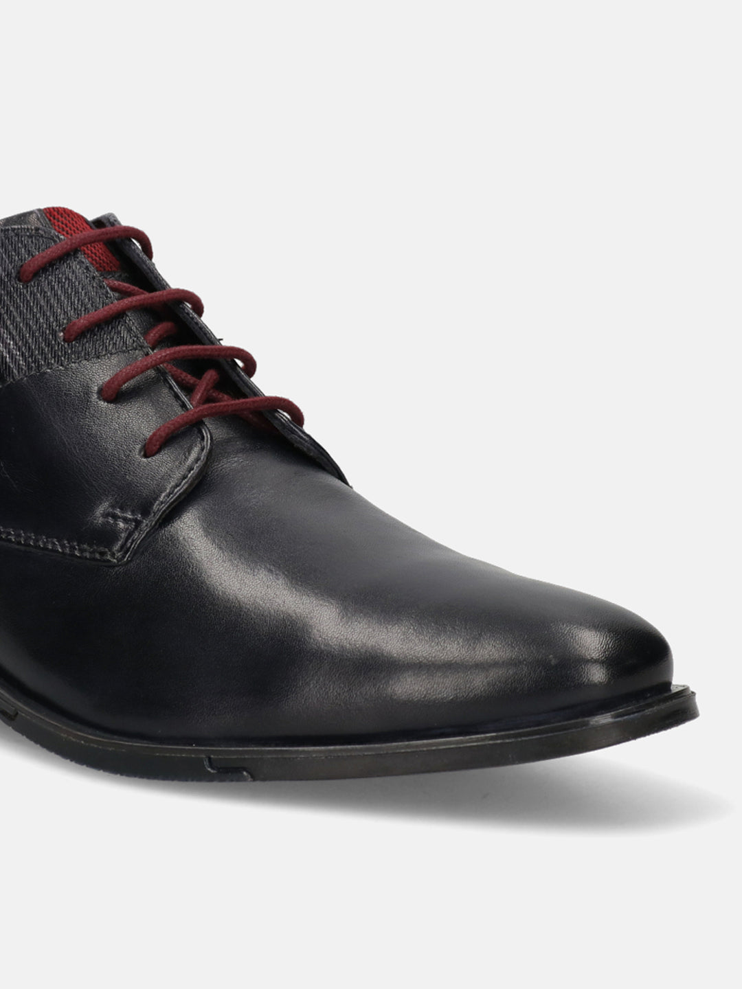 Dark blue leather chukka boot by bugatti with red laces and herringbone fabric on the heel.