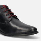 Dark blue leather chukka boot by bugatti with red laces and herringbone fabric on the heel.