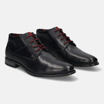 Dark blue leather Chukka boots by bugatti with dark red laces and textured details.