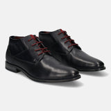 Dark blue leather Chukka boots by bugatti with dark red laces and textured details.