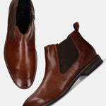 Bugatti Amros cognac Chelsea boots in premium leather, with a brown woven elastic side panel and a side zipper.

