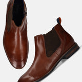 Bugatti Amros cognac Chelsea boots in premium leather, with a brown woven elastic side panel and a side zipper.
