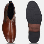 Cognac-colored bugatti leather Chelsea boot with side zipper and contrasting sole, shown in a top-down studio shot.
