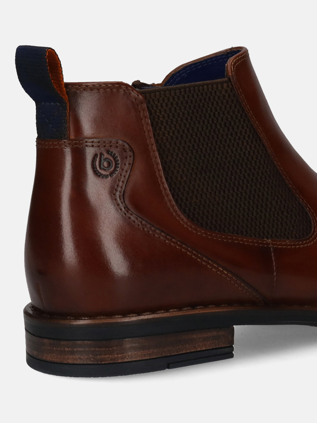 Cropped side view of a brown leather bugatti Chelsea boot featuring elastic side panels and a dark blue pull tab.
