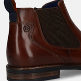 Cropped side view of a brown leather bugatti Chelsea boot featuring elastic side panels and a dark blue pull tab.
