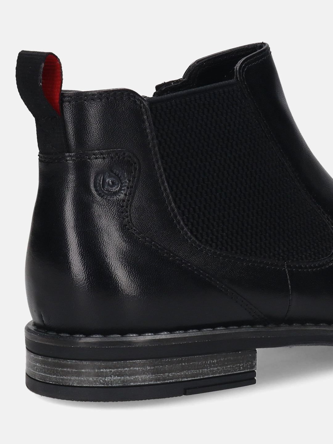 back view of a black bugatti premium leather Chelsea boot, featuring a red-lined pull tab and elastic side panel.
