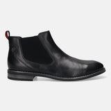 Side view of a black, leather bugatti Chelsea boot featuring elastic side panels and a small, red pull tab.
