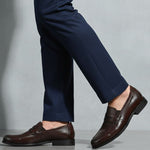 bugatti Theobaldo dark brown premium leather penny loafers, complemented by navy dress pants.
