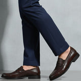 bugatti Theobaldo dark brown premium leather penny loafers, complemented by navy dress pants.
