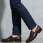 bugatti Theobaldo dark brown premium leather penny loafers, complemented by navy dress pants.
