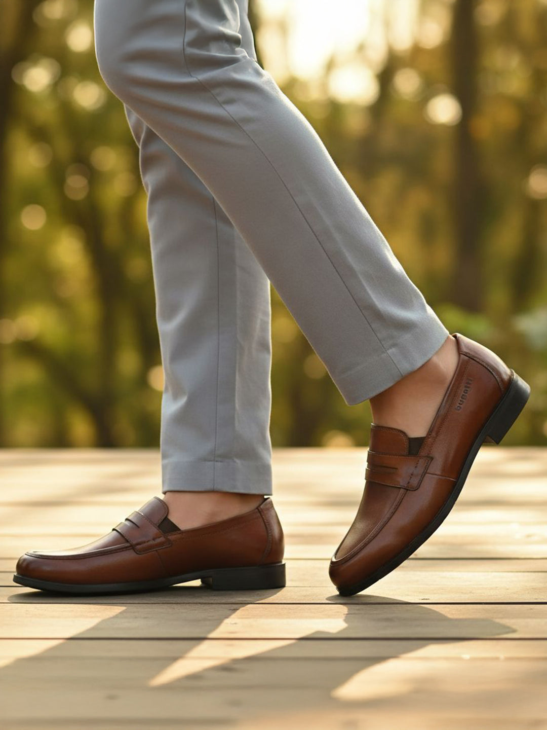 Men's Bugatti penny loafer cognac leather shoes with a pointed toe and apron toe featuring a moulded heel , a tpr outsole.