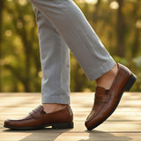 Men's Bugatti penny loafer cognac leather shoes with a pointed toe and apron toe featuring a moulded heel , a tpr outsole.