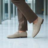 bugatti Tryst sand premium leather comfort penny loafers, beige suede with a dark sole, lifestyle close up.