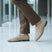 bugatti Tryst sand premium leather comfort penny loafers, beige suede with a dark sole, lifestyle close up.