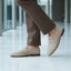 bugatti Tryst sand premium leather comfort penny loafers, beige suede with a dark sole, lifestyle close up.
