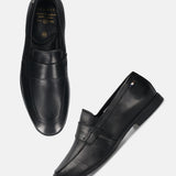 Black leather loafers by bugatti, featuring a penny loafer strap and top stitching.