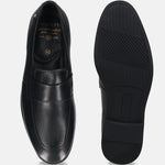 Black leather comfort penny loafers by Bugatti with textured rubber soles and a smooth finish.