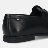 Black leather loafer by bugatti with a penny strap, featuring a striped accent and textured sole, back view.