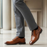 bugatti Mero cognac premium leather derby formal shoes with black laces, styled with gray dress pants and black socks.
