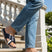 bugatti Limon dark blue leather sandals with cross straps, worn with jeans on stairs.
