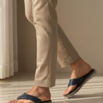Lifestyle view of bugatti Limon sandals in dark blue premium leather, a comfortable thong style.
