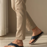 Lifestyle view of bugatti Limon sandals in dark blue premium leather, a comfortable thong style.
