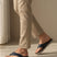 Lifestyle view of bugatti Limon sandals in dark blue premium leather, a comfortable thong style.
