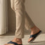 Lifestyle view of bugatti Limon sandals in dark blue premium leather, a comfortable thong style.
