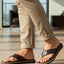 bugatti Limon dark brown premium leather thong sandals, shown on a man wearing beige pants.