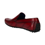 A red leather bugatti loafer with debossed logos and a black, nubbed heel.
