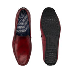 Bugatti Tresmo slip-on shoes in dark red leather, featuring the brand's name as a pattern and black soles.