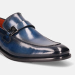 Blue leather penny loafer by bugatti featuring a metal buckle detail and black sole.