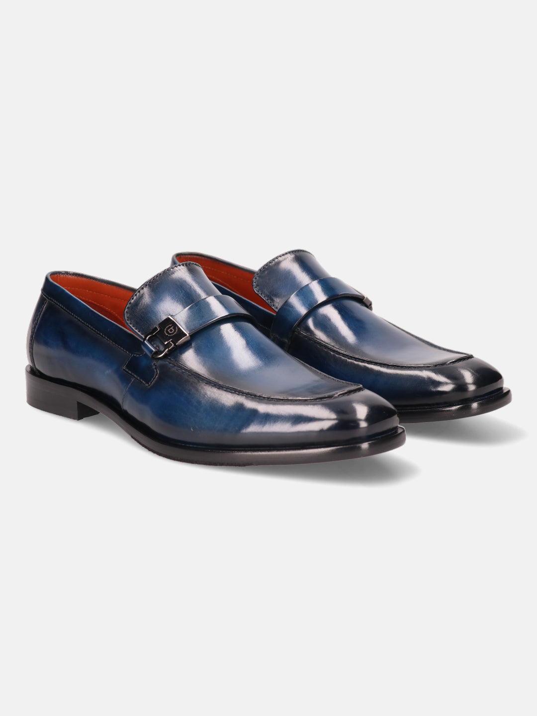 Blue leather penny loafers by bugatti with a metal accent on the strap and bright orange lining.