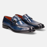 Blue leather penny loafers by bugatti with a metal accent on the strap and bright orange lining.