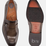 Dark green leather penny loafer by bugatti showing the insole and sole of the shoe.