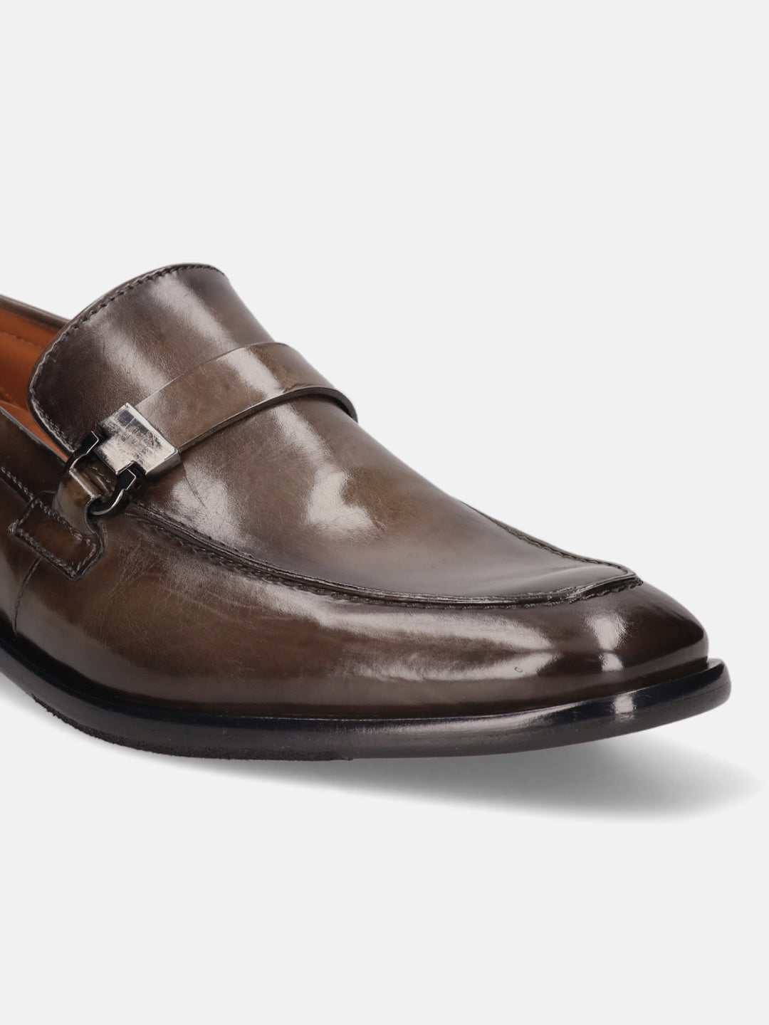 Dark green leather penny loafer by bugatti with a silver-tone decorative buckle.