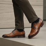bugatti Livorno Flex Evo cognac leather formal shoes, visible with dark socks and dress pants.
