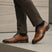 bugatti Livorno Flex Evo cognac leather formal shoes, visible with dark socks and dress pants.
