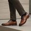 bugatti Livorno Flex Evo cognac leather formal shoes, visible with dark socks and dress pants.
