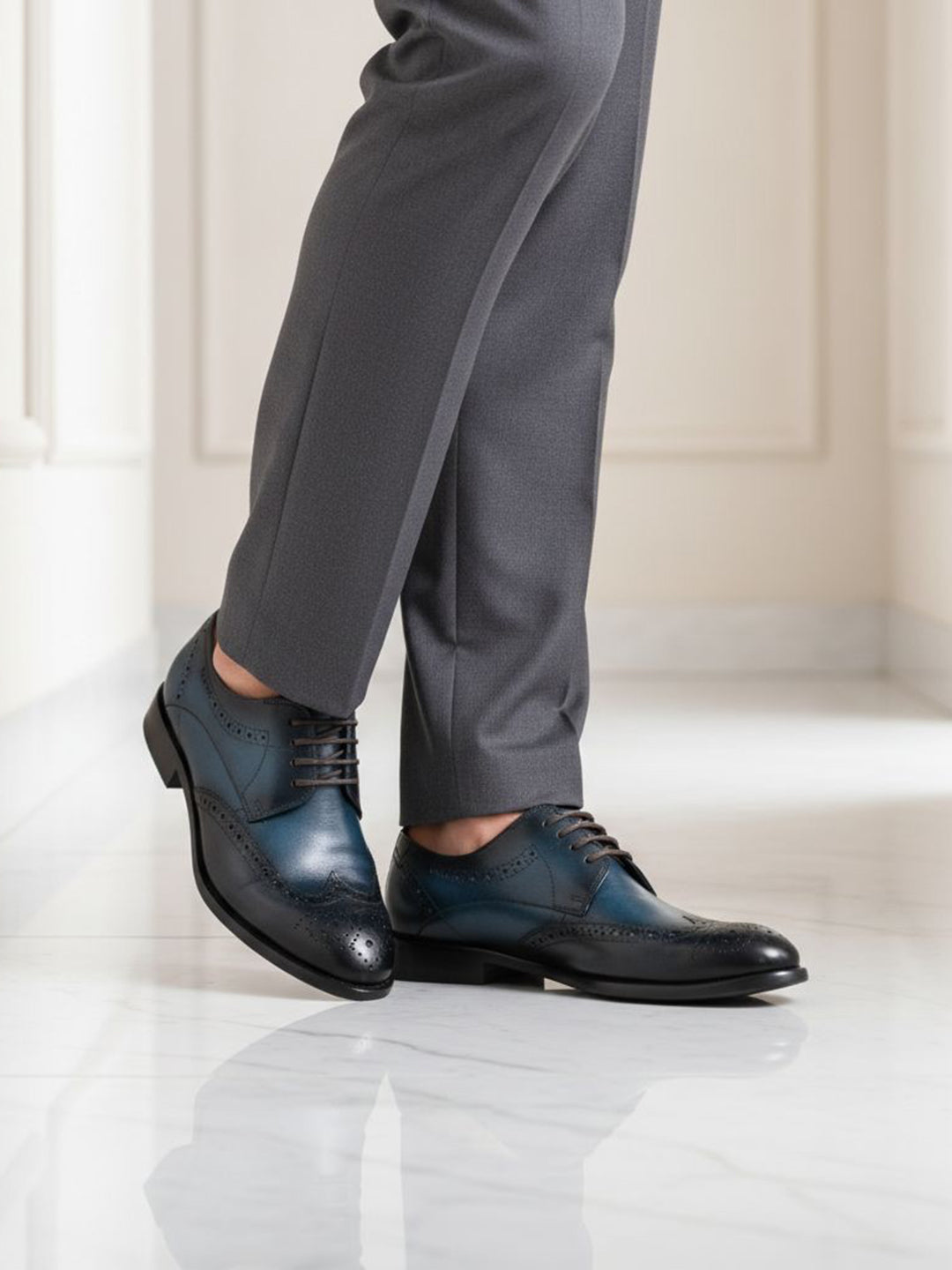 bugatti Livorno Flex Evo dark blue leather derby shoes with black accents, styled with gray dress pants.
