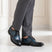 bugatti Livorno Flex Evo dark blue leather derby shoes with black accents, styled with gray dress pants.
