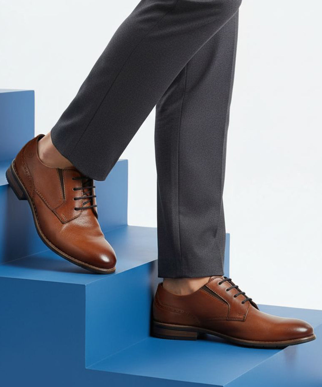 bugatti Livorno Flex Evo cognac leather derby shoe with black laces on blue steps.